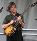 A person holding a guitar

Description automatically generated